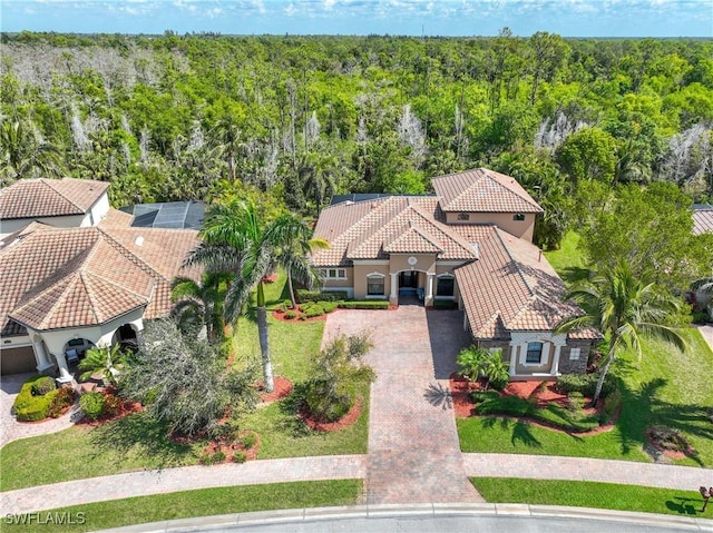 drone / aerial view with a wooded view