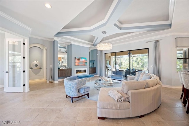 living area featuring light tile patterned flooring, plenty of natural light, ornamental molding, and a glass covered fireplace