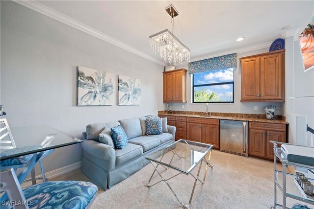 living room featuring an inviting chandelier, baseboards, crown molding, and light colored carpet