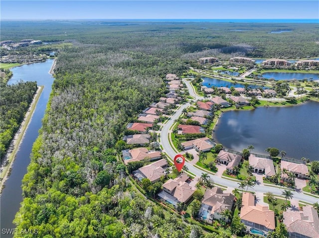 drone / aerial view with a water view and a residential view