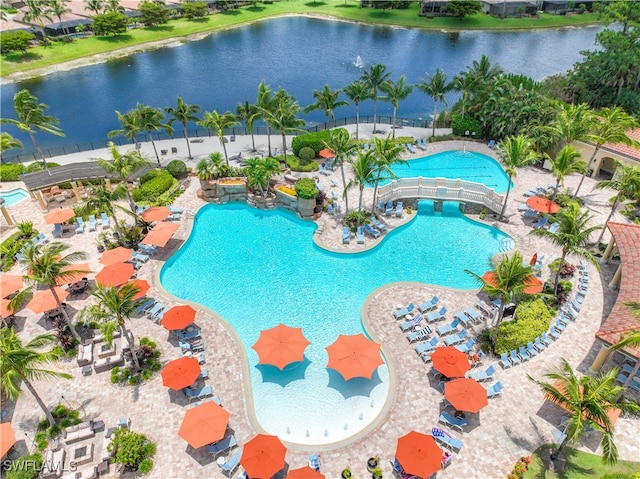 view of swimming pool featuring a patio area and a water view