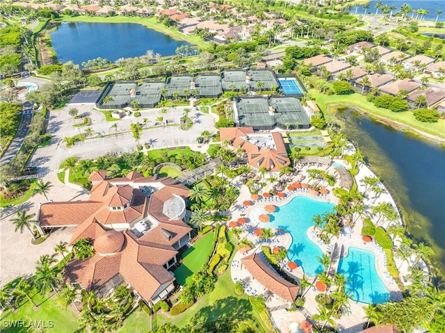 drone / aerial view featuring a water view and a residential view