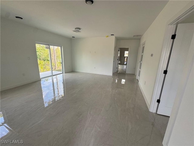 unfurnished room featuring marble finish floor, visible vents, and baseboards