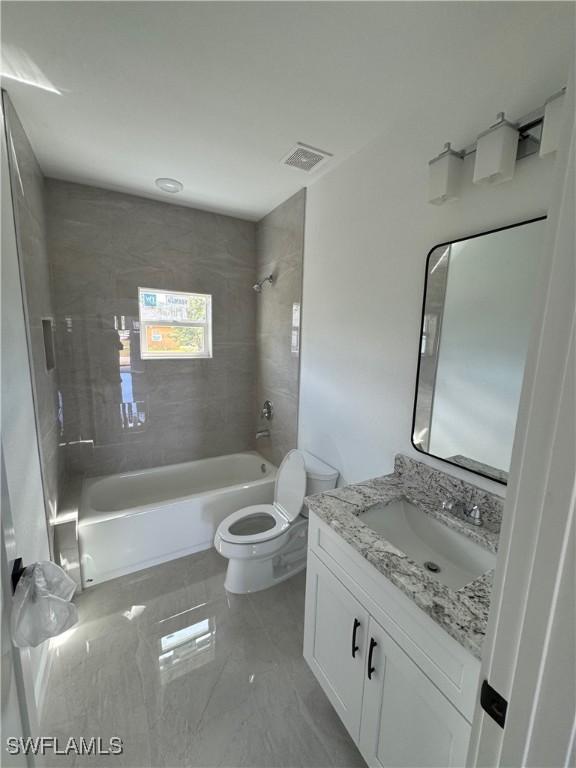 bathroom featuring visible vents, shower / bathing tub combination, vanity, and toilet