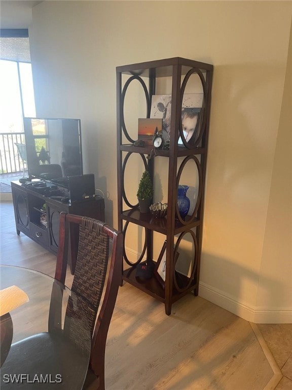 dining area with light wood-style flooring and baseboards