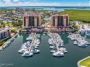 drone / aerial view featuring a view of city and a water view