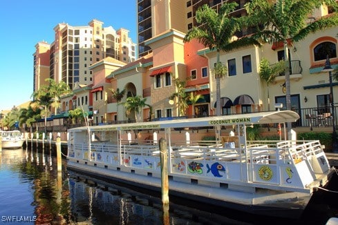 view of home's community featuring a dock and a water view