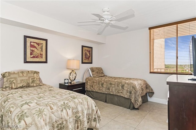 bedroom featuring ceiling fan, baseboards, and light tile patterned floors