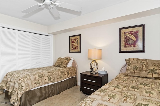 tiled bedroom with a closet and ceiling fan