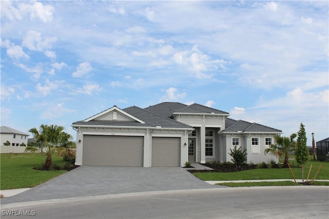 view of front of property featuring an attached garage, decorative driveway, a front yard, and stucco siding