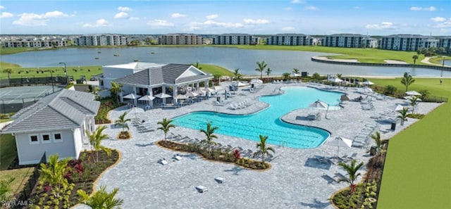 pool with a water view and a patio area