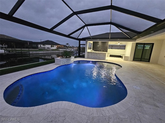 pool with a patio area and glass enclosure