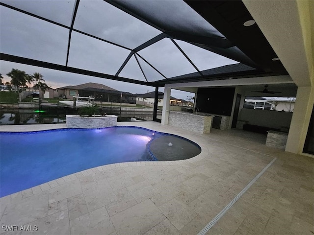 outdoor pool featuring a patio area and a lanai