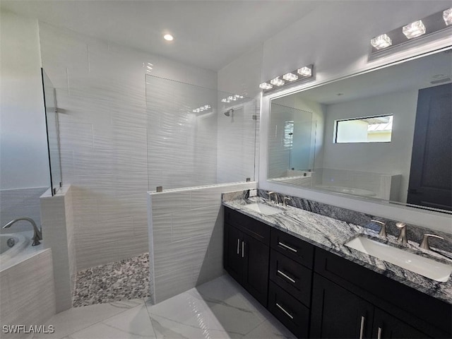 full bathroom featuring a bath, walk in shower, and a sink