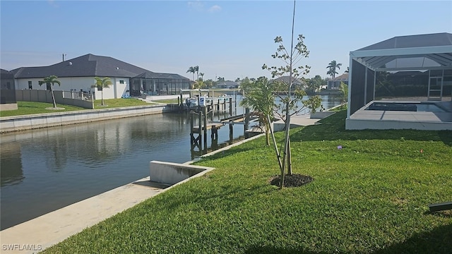 view of dock with a lanai, a yard, a residential view, and a water view