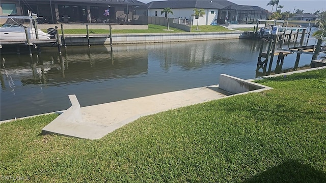 view of dock featuring boat lift, a residential view, a lawn, and a water view