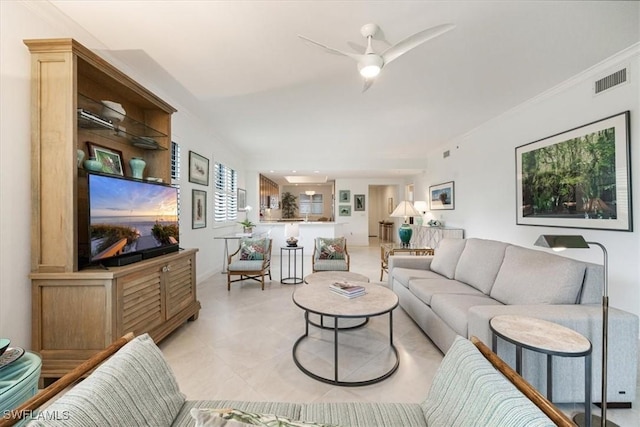 living area featuring ceiling fan, visible vents, and crown molding