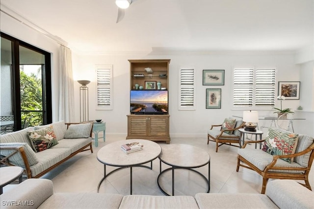 living room featuring crown molding, baseboards, and light tile patterned floors