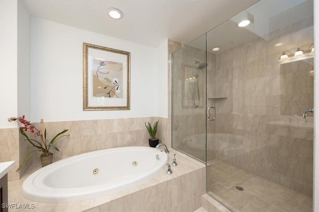 bathroom with a tub with jets, a shower stall, vanity, and recessed lighting