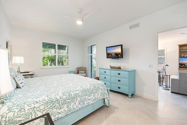 bedroom with light tile patterned floors, ceiling fan, visible vents, and baseboards