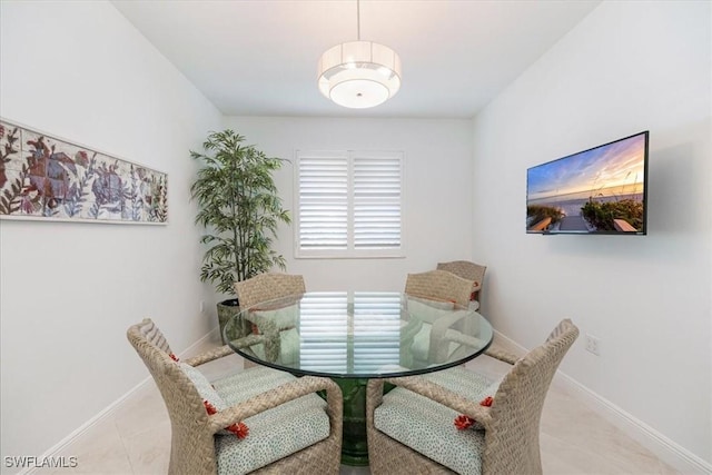 dining room with baseboards and light tile patterned floors