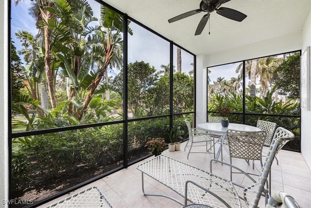 unfurnished sunroom featuring a ceiling fan