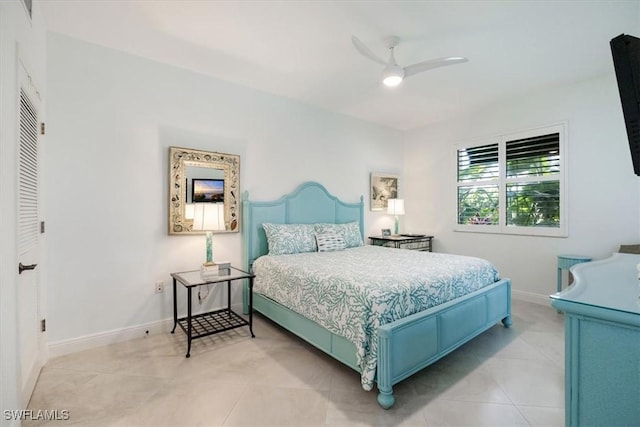 bedroom featuring ceiling fan, baseboards, and light tile patterned floors