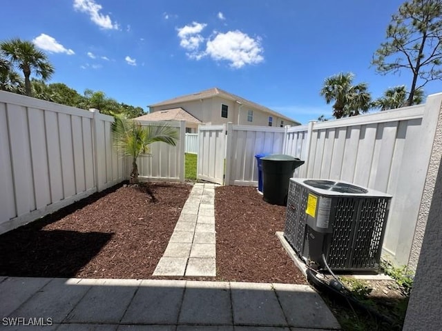 view of yard with a fenced backyard and cooling unit