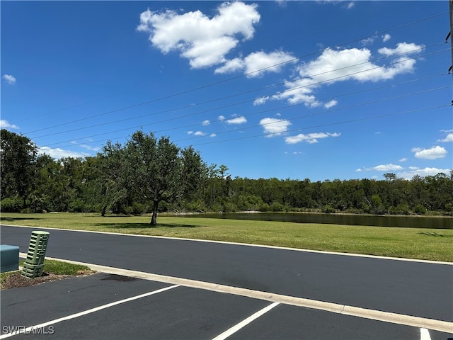 view of street with a water view and a wooded view