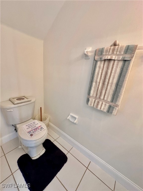 bathroom featuring tile patterned flooring, toilet, and baseboards