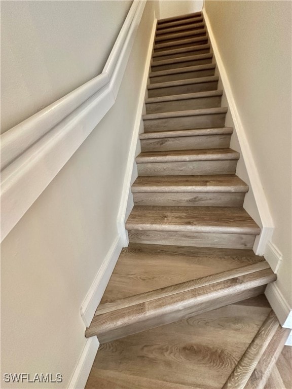 staircase with wood finished floors