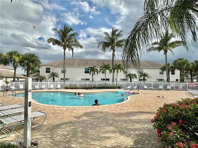 pool featuring a patio area and fence