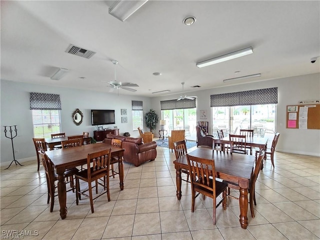 dining room featuring visible vents, plenty of natural light, and light tile patterned floors