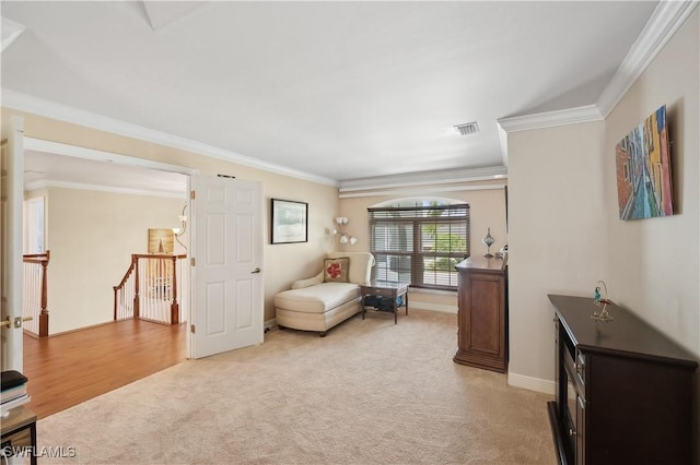 living area with baseboards, light carpet, an upstairs landing, crown molding, and visible vents