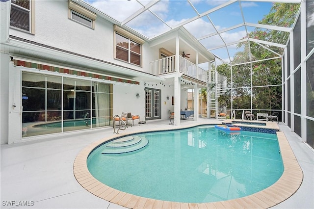 view of pool featuring a lanai, french doors, a patio area, and ceiling fan