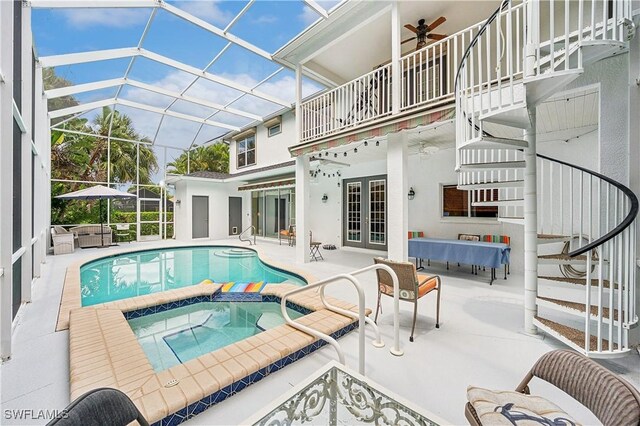 view of pool featuring french doors, a ceiling fan, a patio area, a lanai, and a pool with connected hot tub