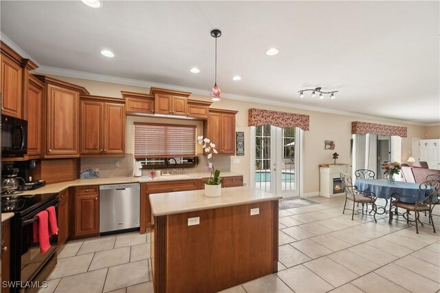 kitchen featuring brown cabinets, light countertops, black appliances, and a kitchen island