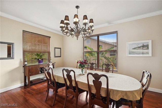 dining space featuring an inviting chandelier, dark wood-type flooring, baseboards, and ornamental molding