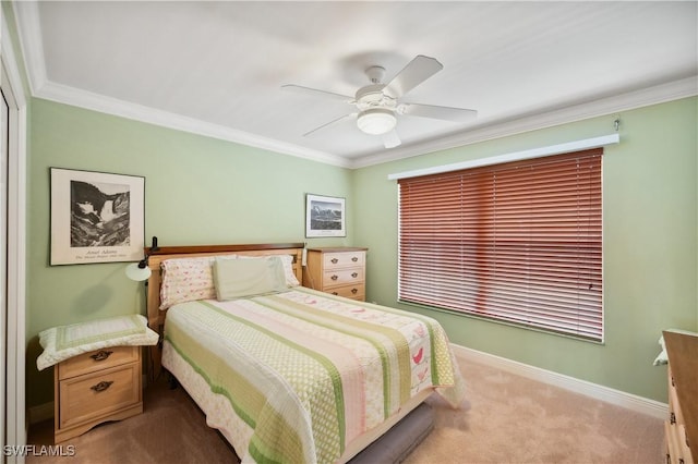 bedroom featuring carpet, baseboards, ornamental molding, and a ceiling fan