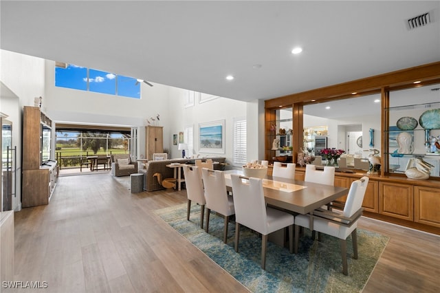 dining area with light wood-type flooring, visible vents, and recessed lighting