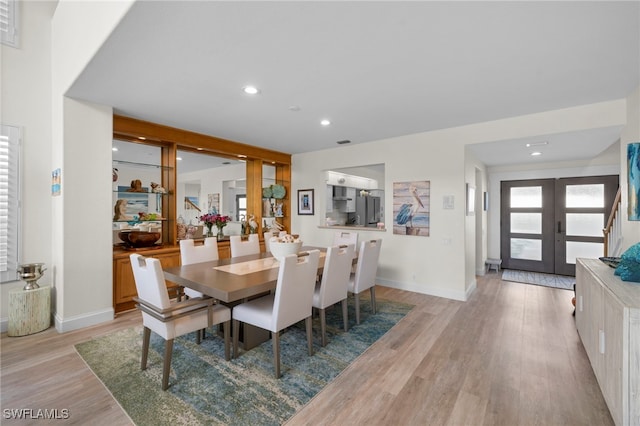 dining area with recessed lighting, french doors, light wood-style flooring, and baseboards