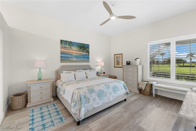 bedroom with light wood finished floors and a ceiling fan