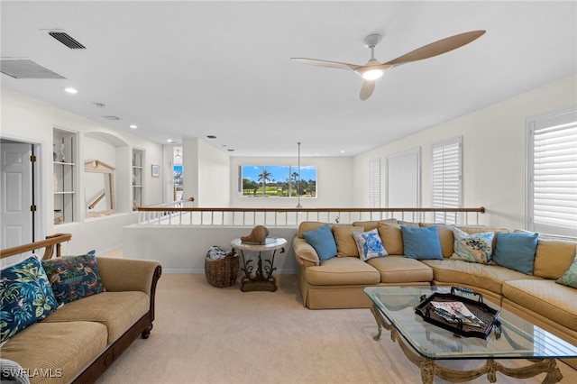 living area featuring built in features, visible vents, ceiling fan, carpet flooring, and recessed lighting