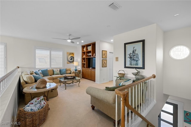 living area with a ceiling fan, recessed lighting, light carpet, and visible vents