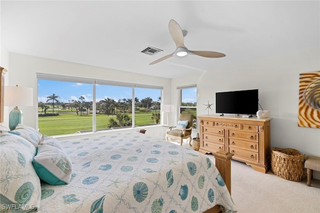 carpeted bedroom featuring visible vents and a ceiling fan