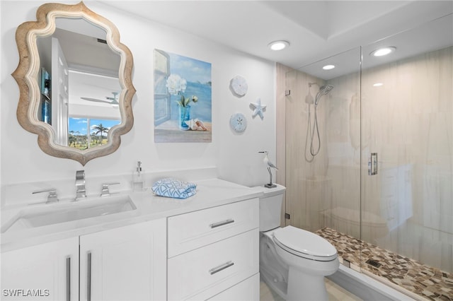 full bath with a stall shower, vanity, toilet, and recessed lighting