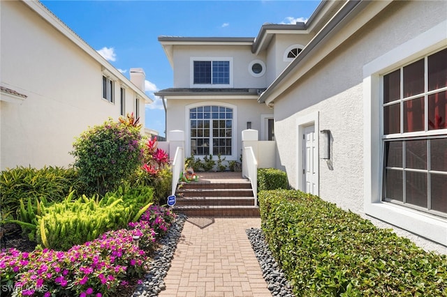 entrance to property with stucco siding