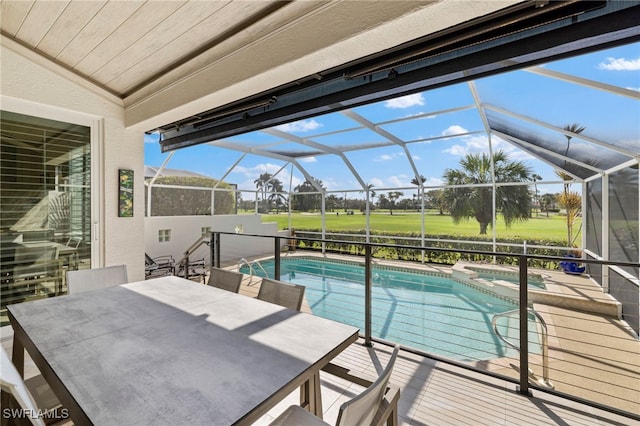 view of pool with glass enclosure, a pool with connected hot tub, outdoor dining area, and a patio