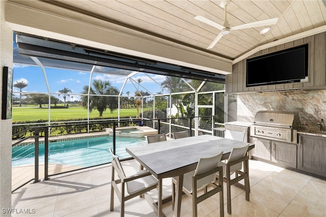 view of pool featuring a patio area, glass enclosure, area for grilling, and a grill