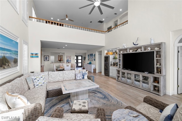 living room with ceiling fan and wood finished floors